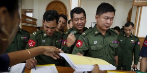 Military representative members of Myanmar's Parliament register as they attend a Parliament meeting at Lower House of Parliament in Naypyitaw